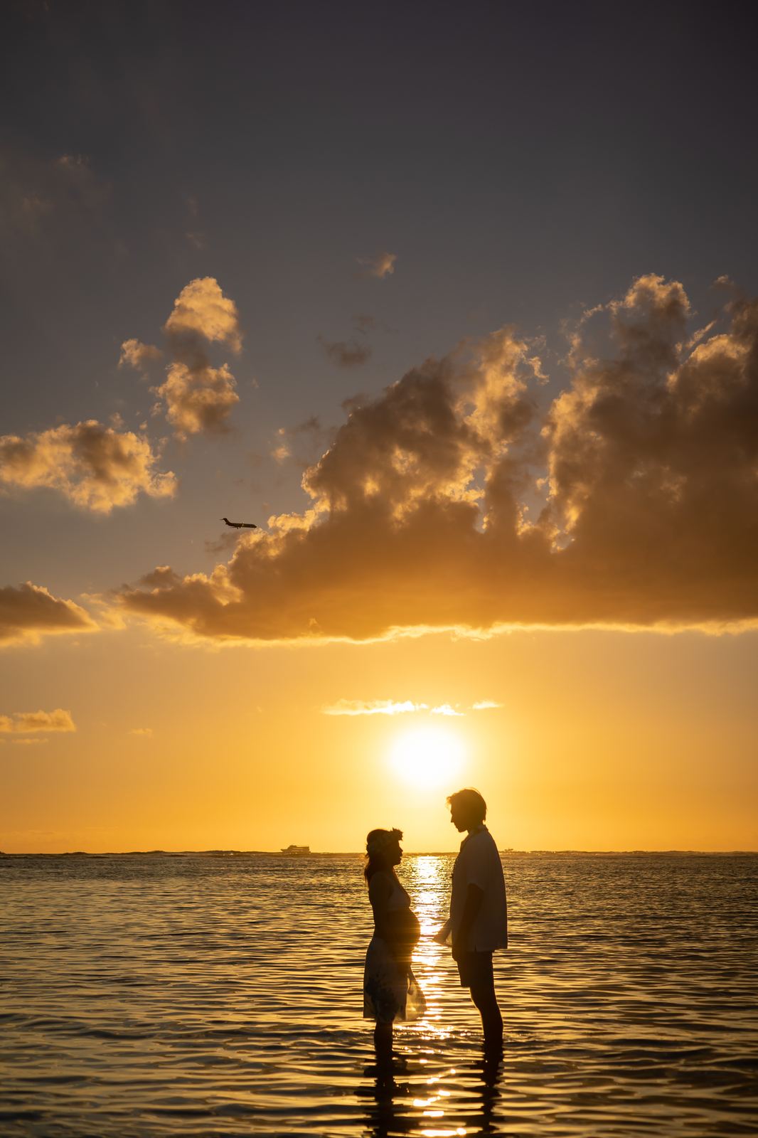 Couple in silhouette under a dramatic sky