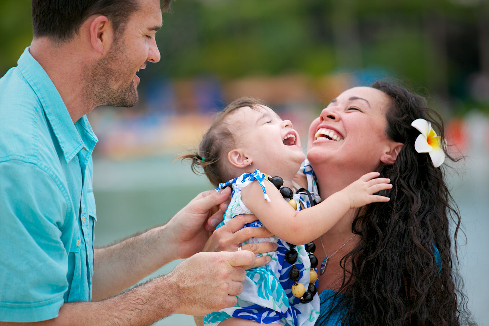 Parents laughing with their toddler