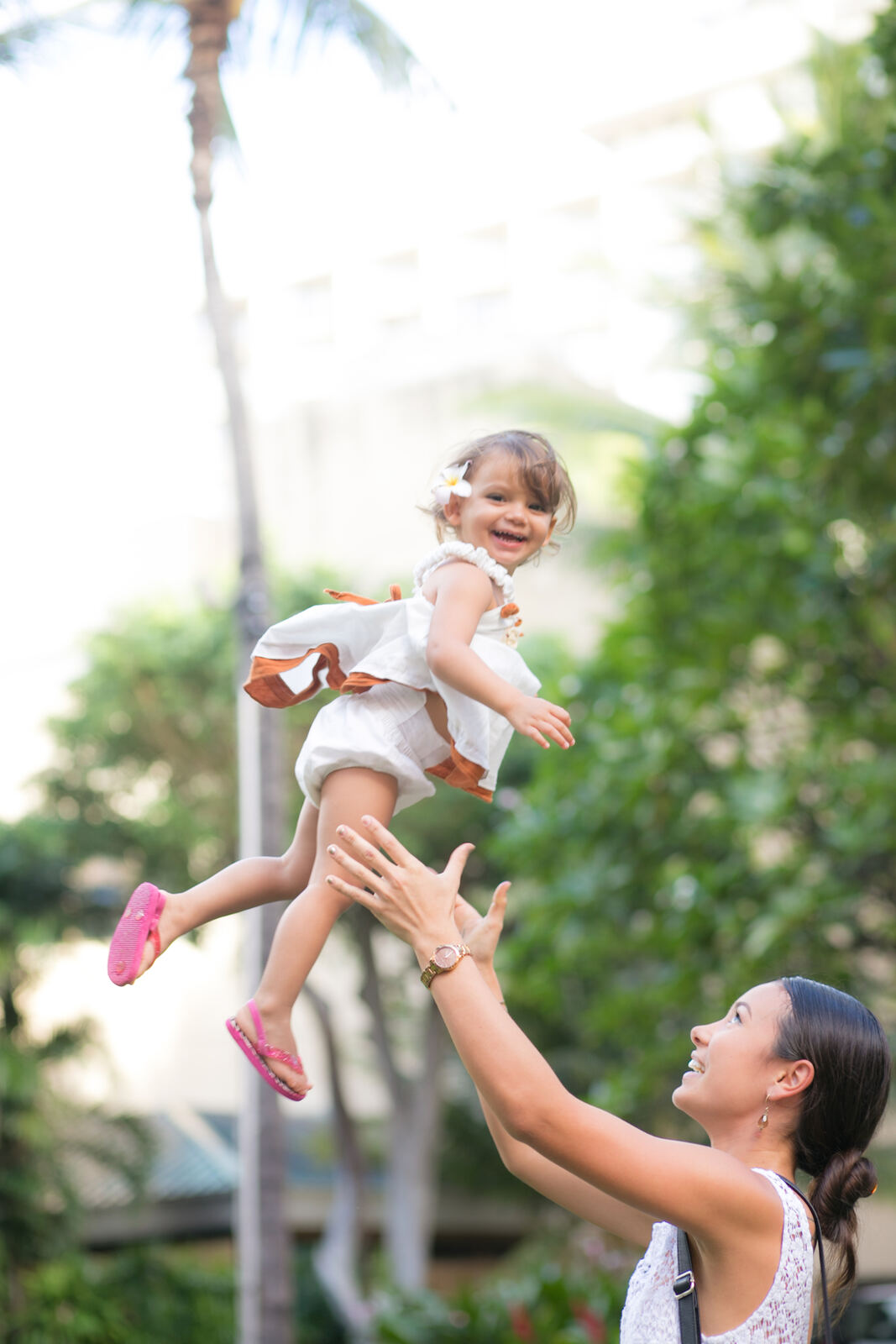 Dad tossing a toddler into the air